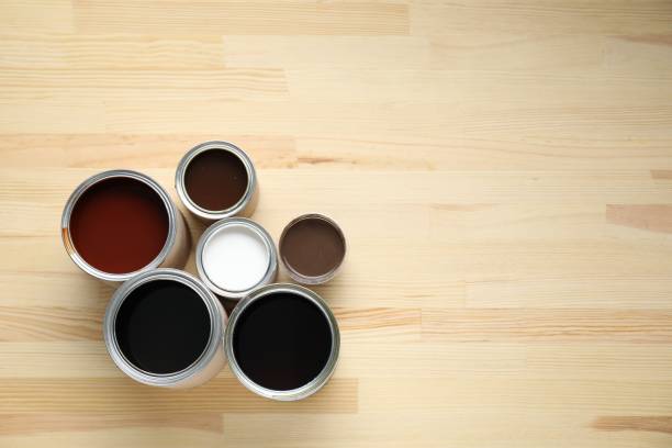 istock Cans with different wood stains and varnish on wooden surface, flat lay. Space for text 1865575146