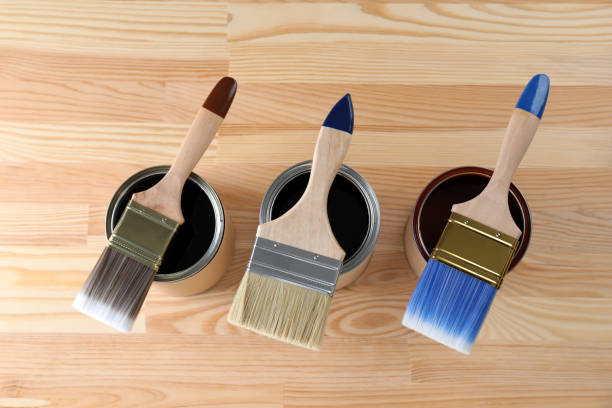 istock Can with different wood stains and brushes on wooden surface, flat lay 1865575661