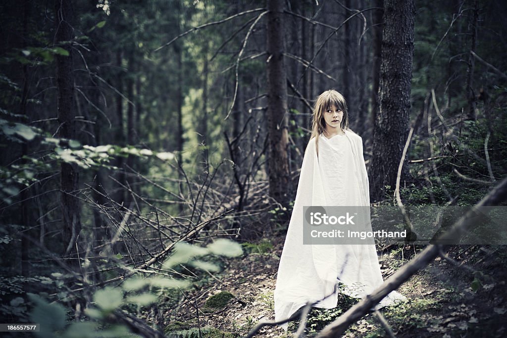 Ghost in dark forest Ghost of a little girl in a forest. Forest Stock Photo