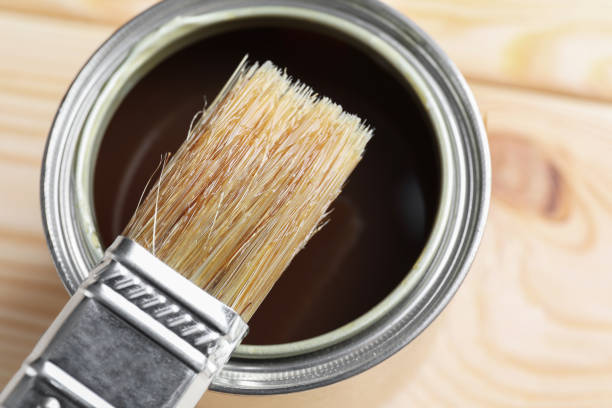 istock Brush over can with varnish on wooden surface, top view 1865576689