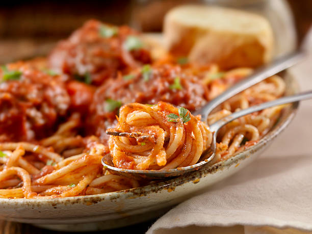 Spaghetti with Large Meatballs Spaghetti with Large Meatballs in a Tomato Basil Sauce with fresh Bread -Photographed on Hasselblad H3-22mb Camera marinara stock pictures, royalty-free photos & images