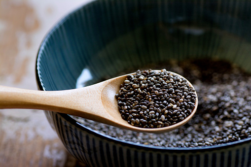 Nutritious chia seeds on a wooden spoon, superfood