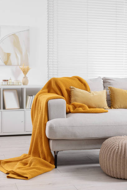 istock Cozy orange plaid on sofa in living room 1865600929