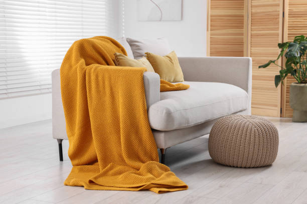 istock Cozy orange plaid on sofa in living room 1865603031