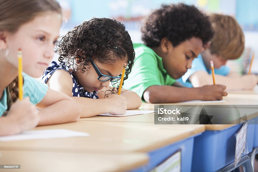 Crianças na escola primária de classe escrevendo - Foto de stock de Exame royalty-free