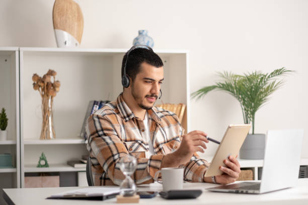 istock young Man working on digital tablet at home 1865621912