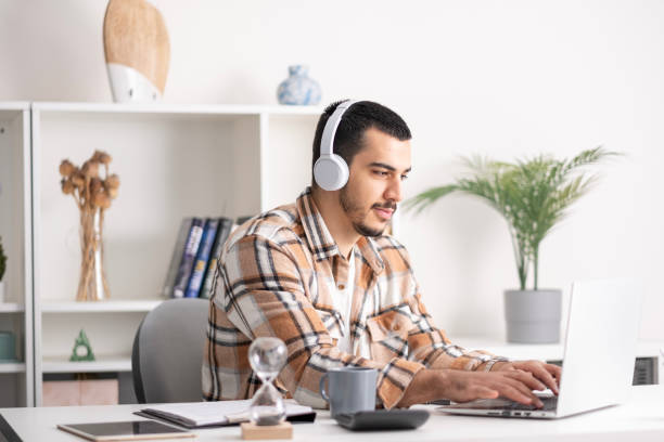 istock young Man working on laptop at home 1865622249
