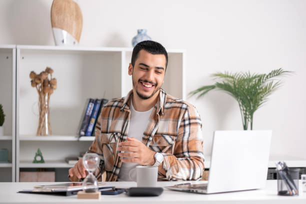 istock young Man working on laptop at home 1865624584