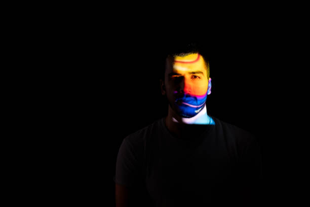 istock Portrait of multicolored handsome man illuminated by neon lights 1865627332