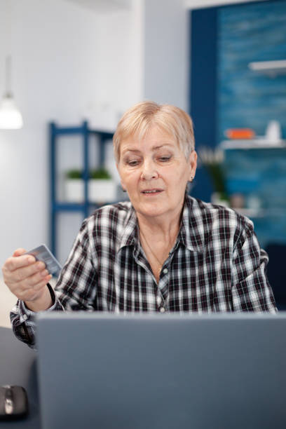 istock Middle aged woman checking bank account 1865627850