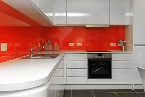 Modern kitchen counter with red backsplash