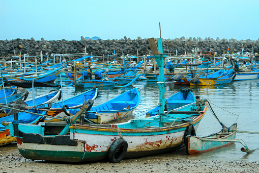 Massawa, Northern Red Sea Region, Eritrea: pier and traditional fishing boats with the Gherar peninsula in the background - Edaga district, Gulf of Zula / Annesley Bay / Baia di Arafali, Red Sea.