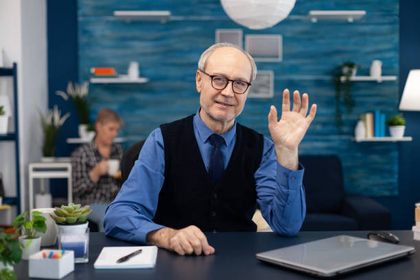 istock Senior businessman waving at camera 1865634776