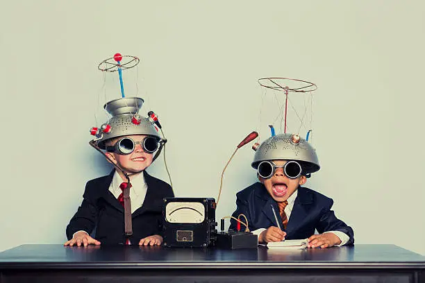 Photo of Boys Dressed as Businessmen Wearing Mind Reading Helmets