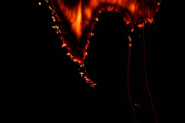 istock burning paper, glowing edge of paper on a black background 1865652681