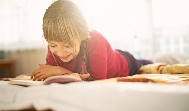 istock Beautiful little girl reading 186565319