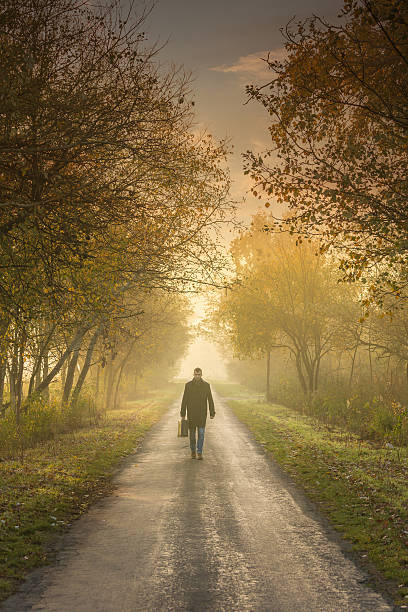 istock young man on the road with a suitcase 186565335