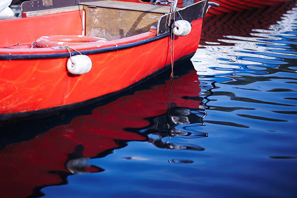 istock Water colors from a fishing boat reflection 186566062