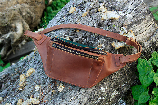 Products made from leather. Bag or sling bag made of brown leather with a minimalist style or retro colors that are minimalist and luxurious. Leather wallet.