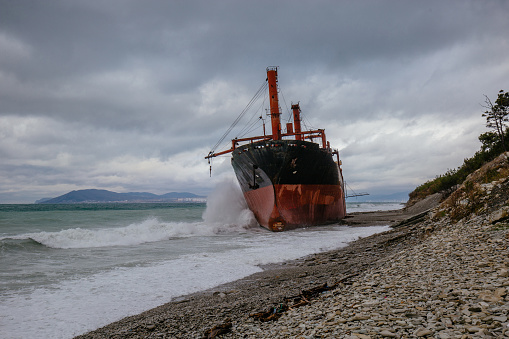 Shipwreck of cargo ship on Black Sea shore.