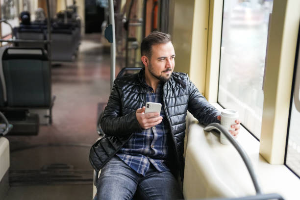 istock Man traveling on public transport talks on his mobile phone 1865671888