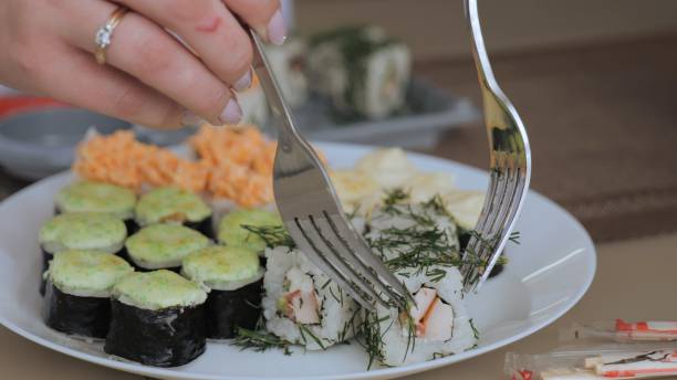 istock Various types of sushi on a white plate. Dinner for two with sushi and wine. 1865674566