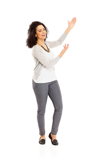istock Cheerful young woman showing coypspace 186567893