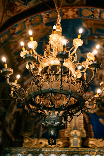 Antique branched chandelier in the Church of the Holy Trinity. Budva, Montenegro. High quality photo