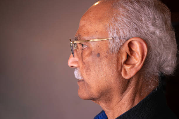 nahaufnahme von muttermalen im gesicht eines 76-jährigen asiatischen inders - eyeball large human eye human nose stock-fotos und bilder