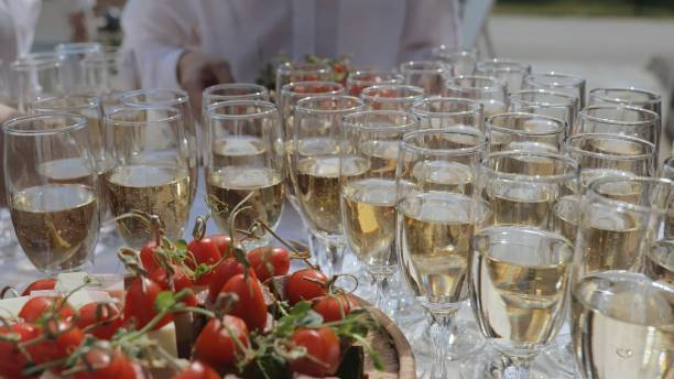 istock Champagne with appetizers on the buffet table. Buffet table, canape with cheese, cherry tomato and olive. Snacks and alcohol for the holiday. 1865687529