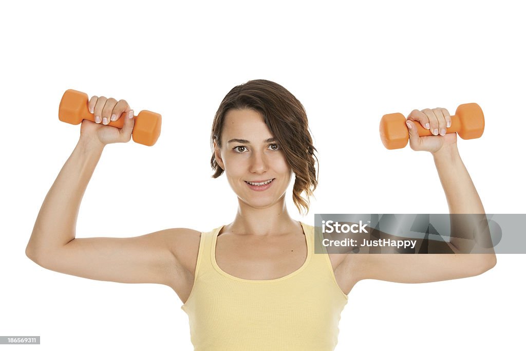 Jeune et jolie femme faire de l'exercice avec les poids et haltères - Photo de Activité libre de droits