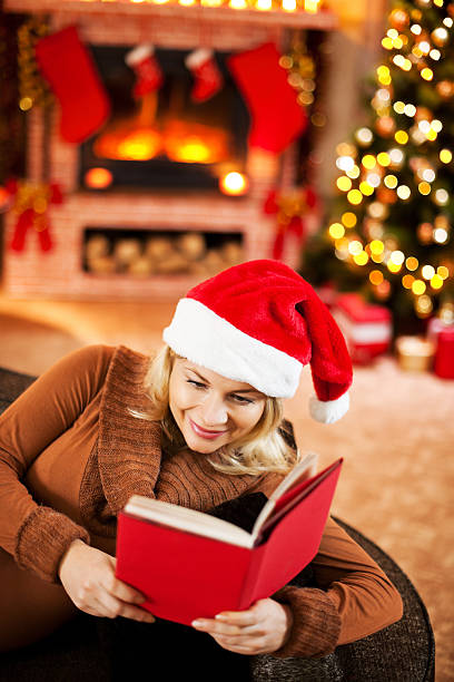 istock Woman reading a book at Christmas. 186569517