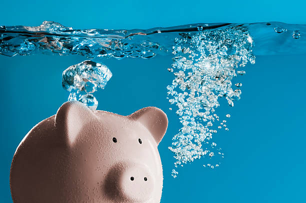 istock A pink piggy bank sinking in water 186569639