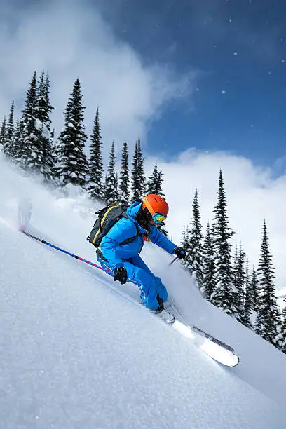 Female skier making turn on powder slope.