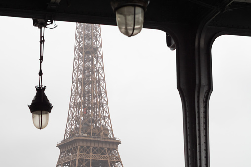 The Eiffel Tower elevator from the Bir Hakeim bridge in the rain in Paris - France