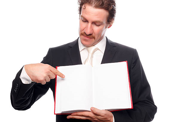 istock Young man showing blank paper in book 186571624