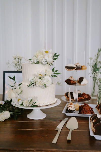 istock Luxurious desert table with cake, cookies, and cupcakes set up at a wedding 1865717652