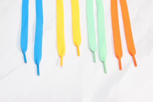 Different  bright colors many shoe laces on white background
