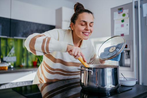 Young brunette cooking in a domestic kitchen