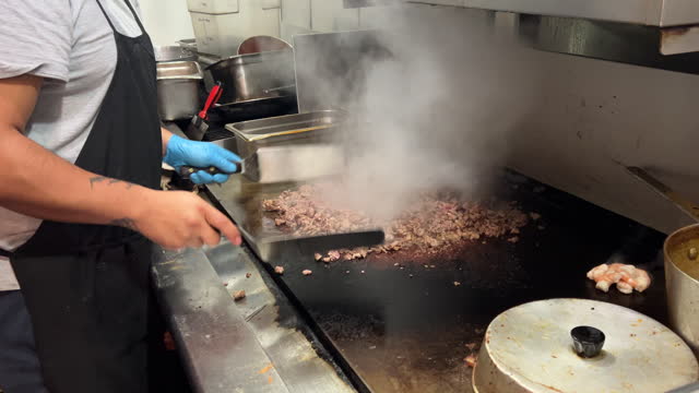 Chef cooking steak tacos at a mexican restaurant