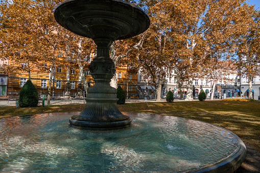 Zrinjevac park and its bronze pool with fountains in Zagreb, the capital of Croatia. The park was built in 1892.