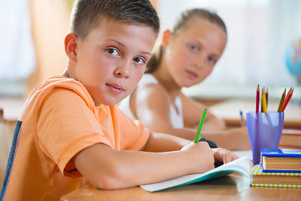 istock Schoolchildren in classroom at school 186574894