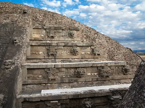 The pyramid of Quetzalcoatl (god of the "feathered serpent") is showing the alternating "Tlaloc" (left, with teeth, a god of rain, fertility, and water) and feathered serpent (right) heads. Dated to some time between 150 and 200 CE, it is part of the Unesco World Heritage site Teotihuacan, Mexico.