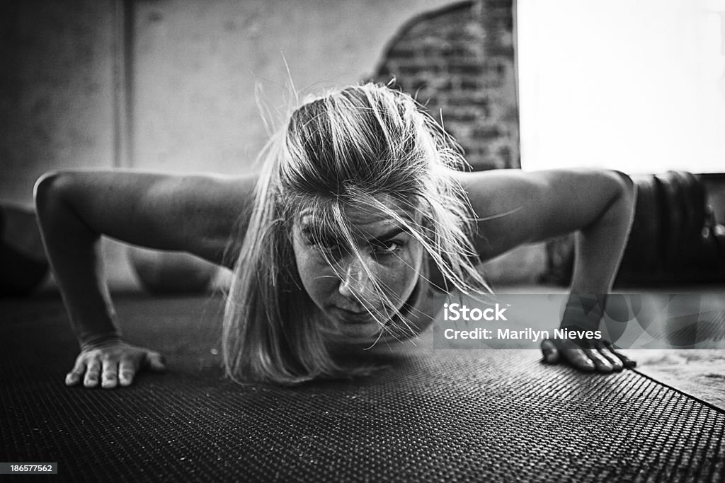 pushups at bootcamp Female doing pushups. Fitness Boot Camp Stock Photo