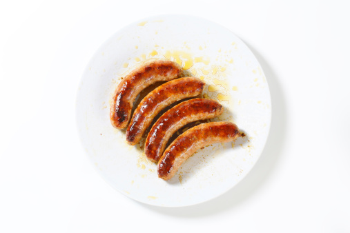 roasted white sausages isolated on white plate