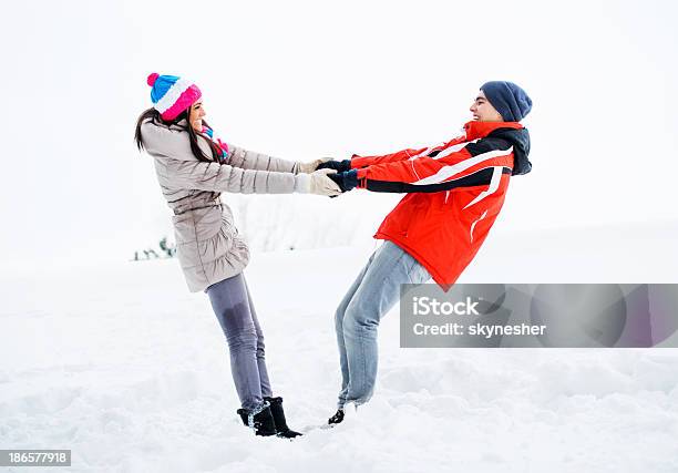 Young Couple Enjoying In The Snow Stock Photo - Download Image Now - Adult, Adults Only, Beautiful People