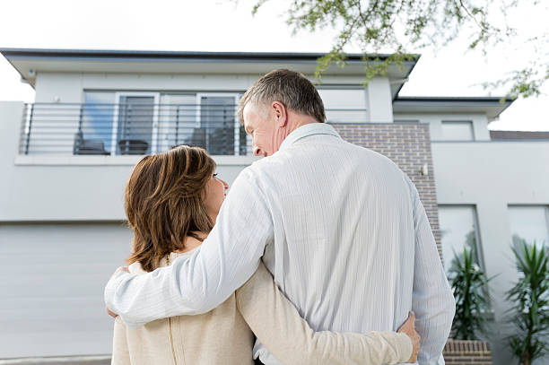 istock Mature couple looking at a house 186578857