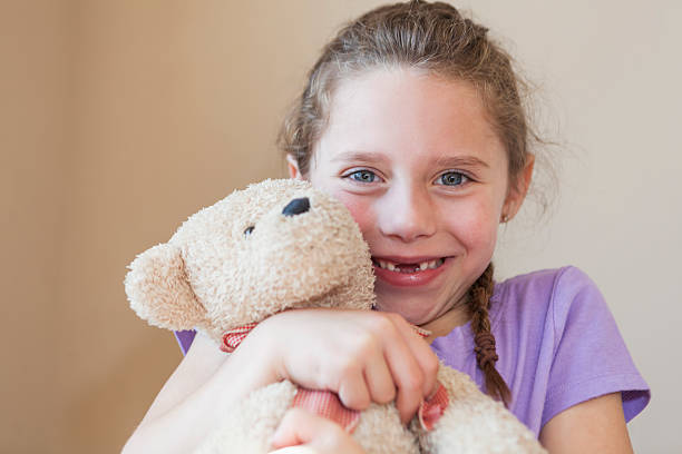 istock Little girl holding teddy bear 186579238