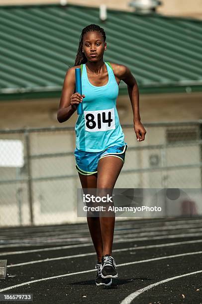 Young Female Track Competitor Running Relay Race Iii Stock Photo - Download Image Now