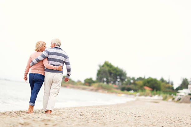 istock Loving senior couple walking on the beach 186580917